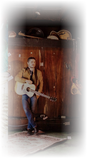 Isaac James Routh with acoustic guitar